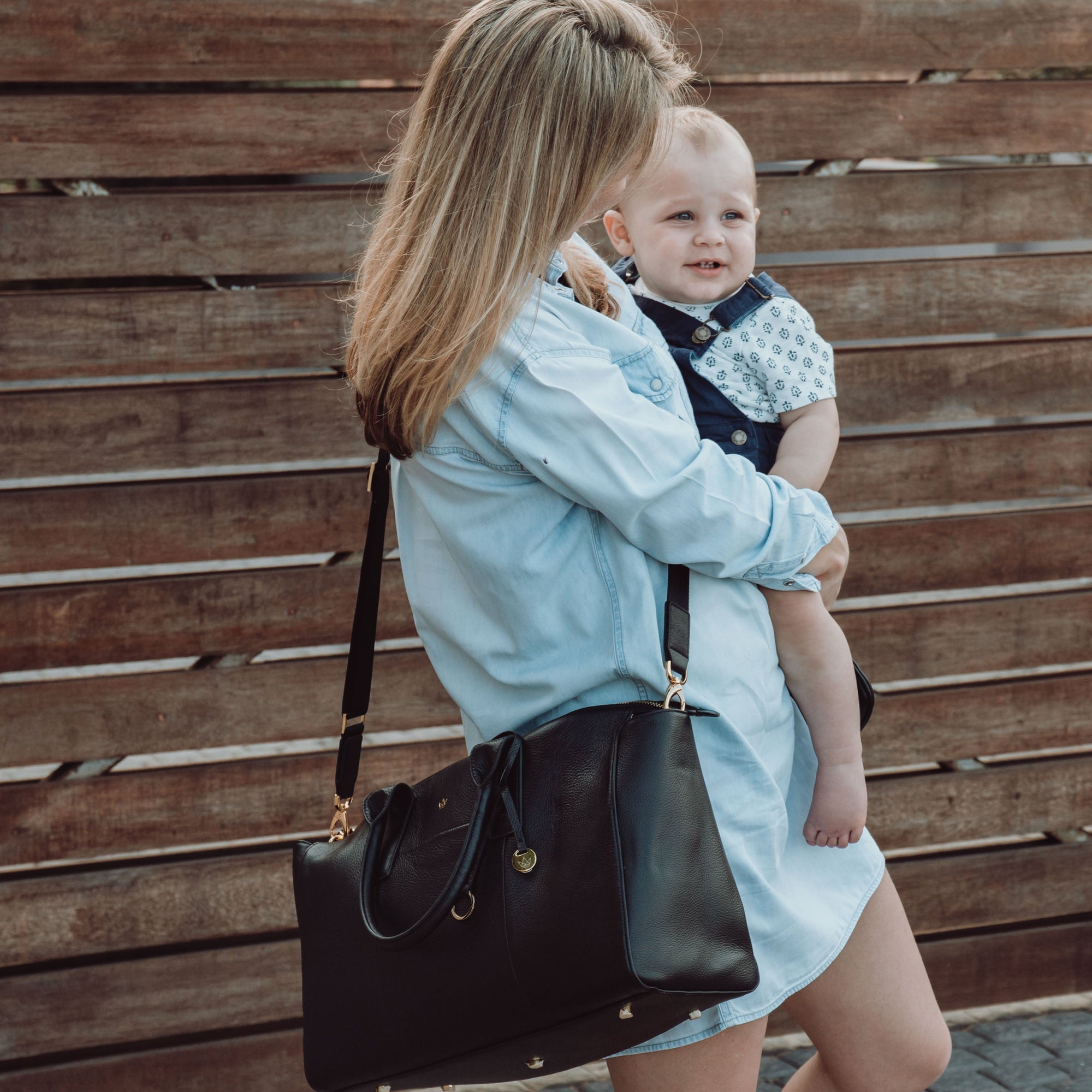 K'lea Belle in Black with Woman holding a baby against 