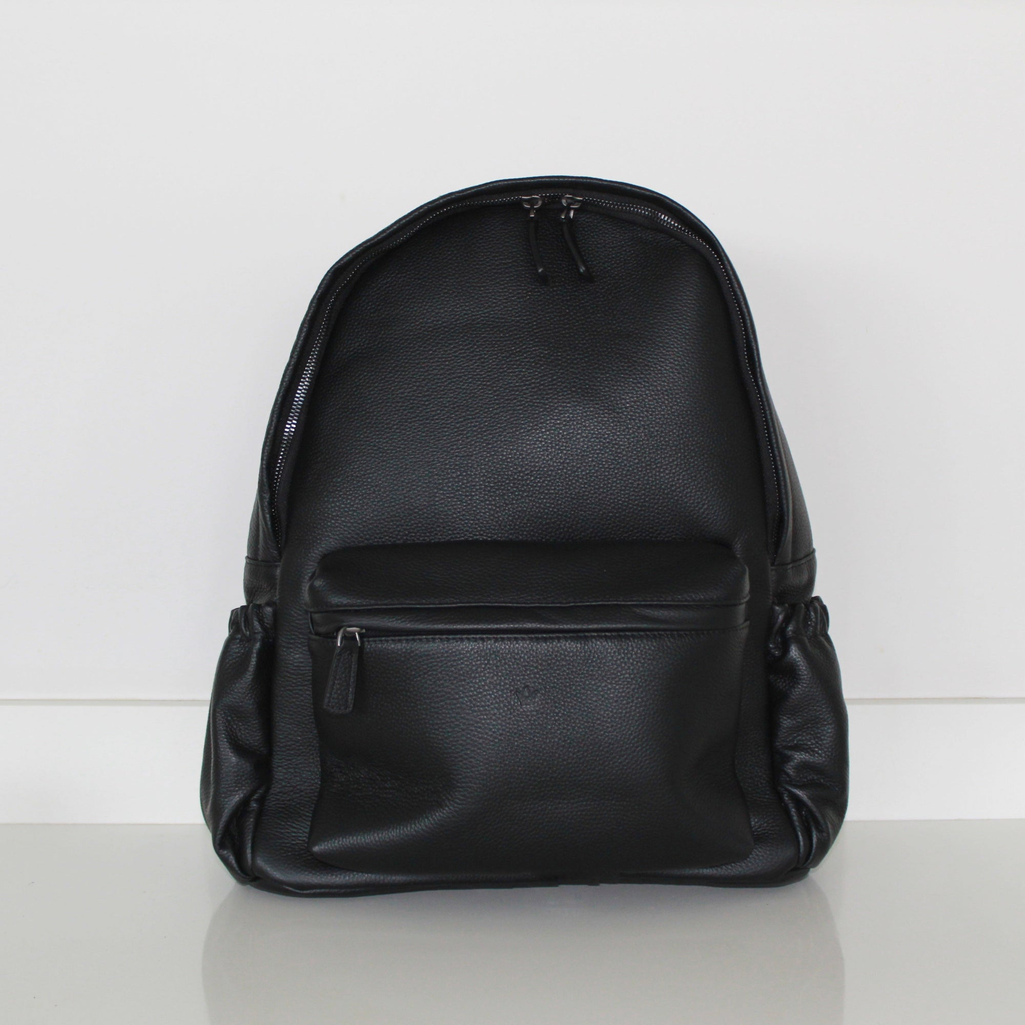 Black genuine leather backpack  handbag and  on a white background